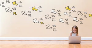 Arrows with little girl using a laptop computer on floor